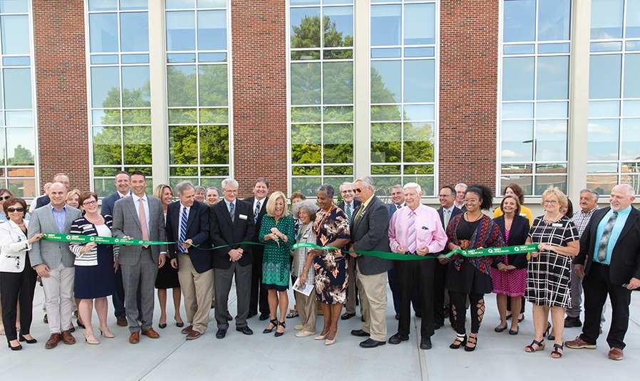 Representatives from teh college and the community participate in a Sept. 7 ribbon-cutting ceremony for Adirondack Hall.