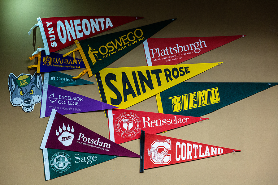 College pennants illustrate various colleges where SUNY Adirondack students can transfer.