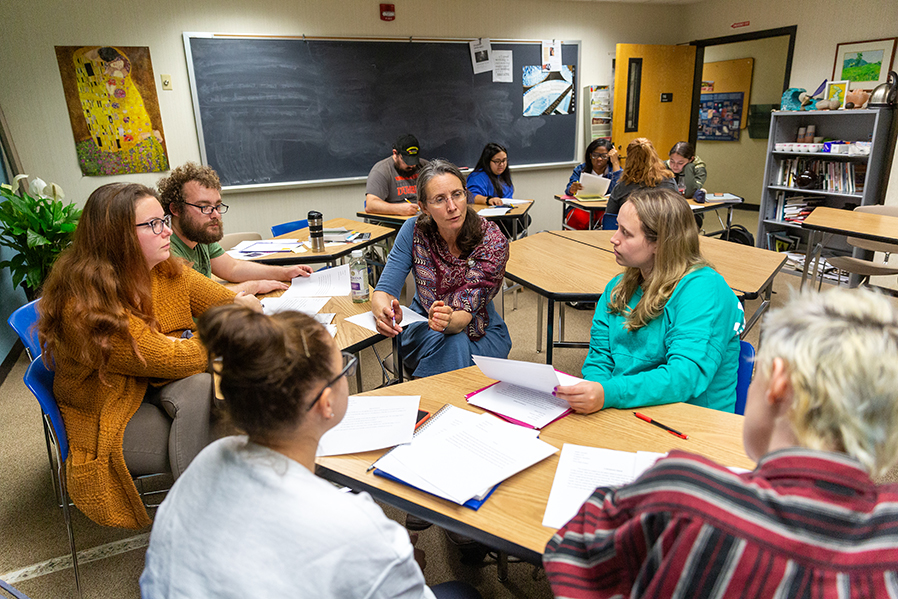 Distinguished Professor of English Lale Davidson works with students on a writing assignment.