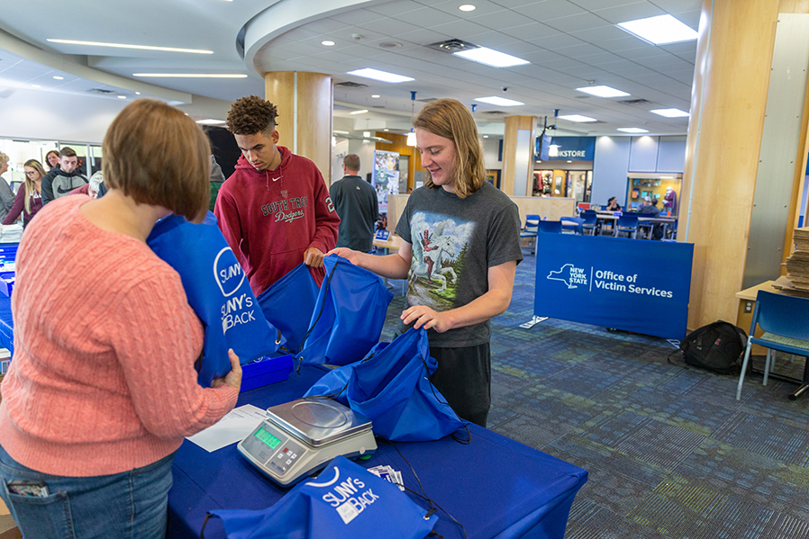 Volunteers assemble comfort kits for domestic violence victims during a SUNY’s Got Your Back event in the Student Center.