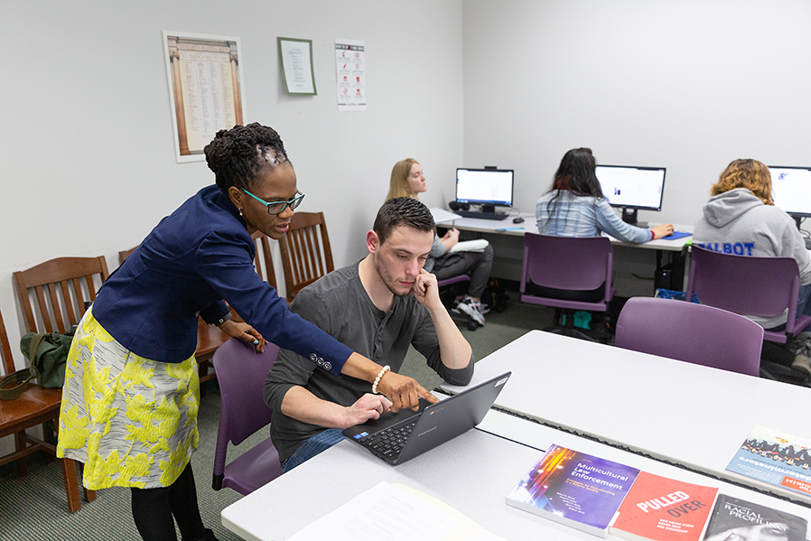Assistant Professor of English Donna Hayles assists a student with a class assignment.