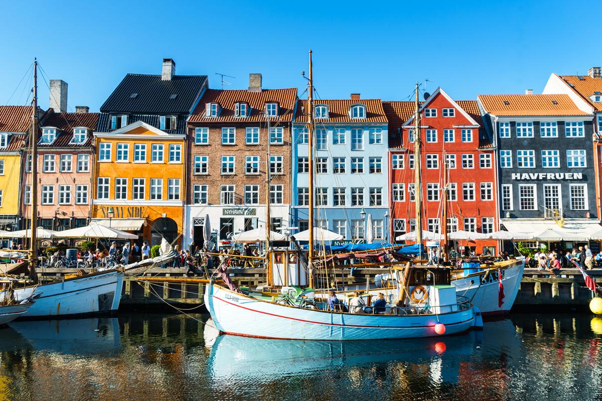 Image of boats on water in front of colorful buildings in Copenhagen