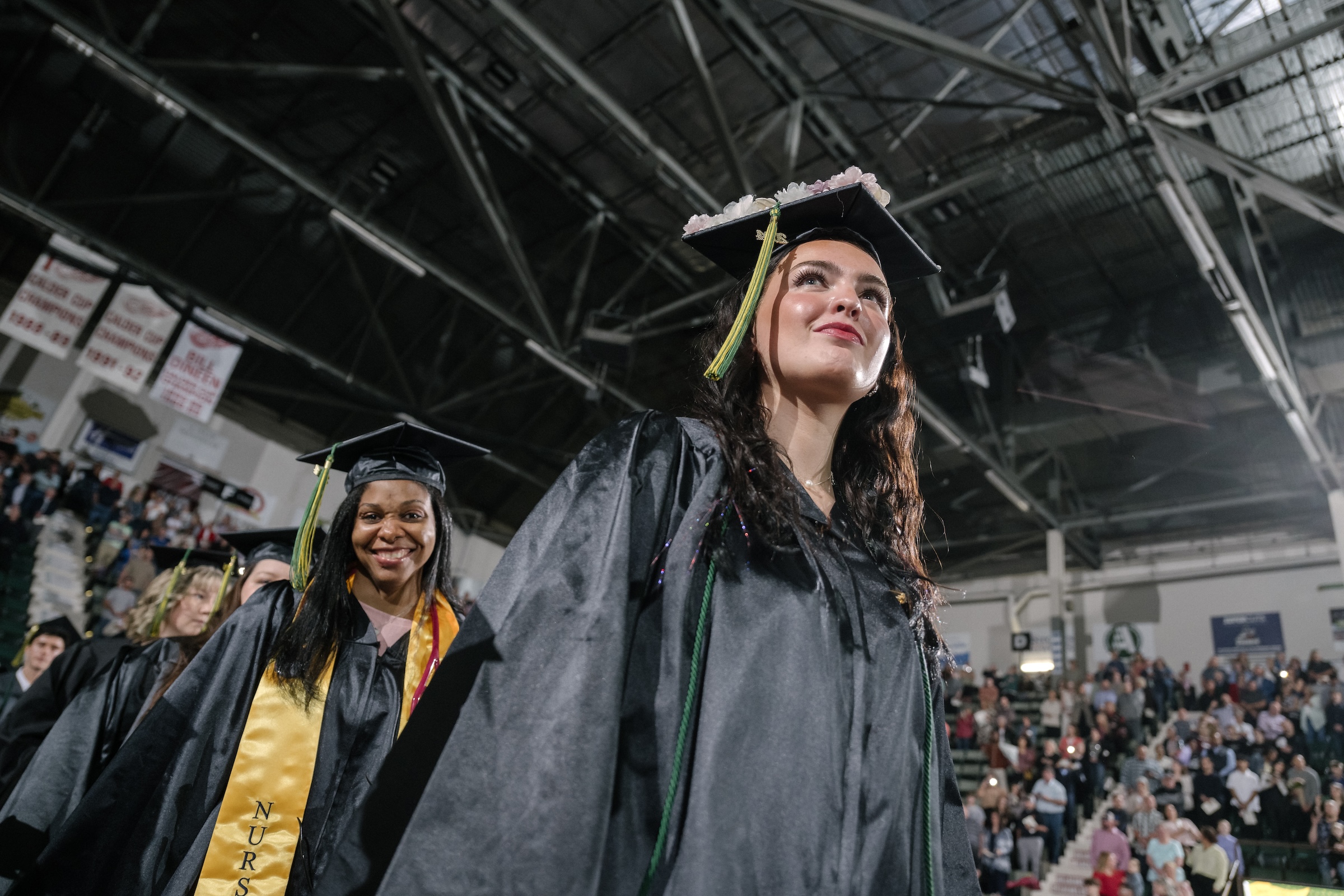 Graduates smile as they enter Cool Insuring Arena at the 2024 commencement ceremony