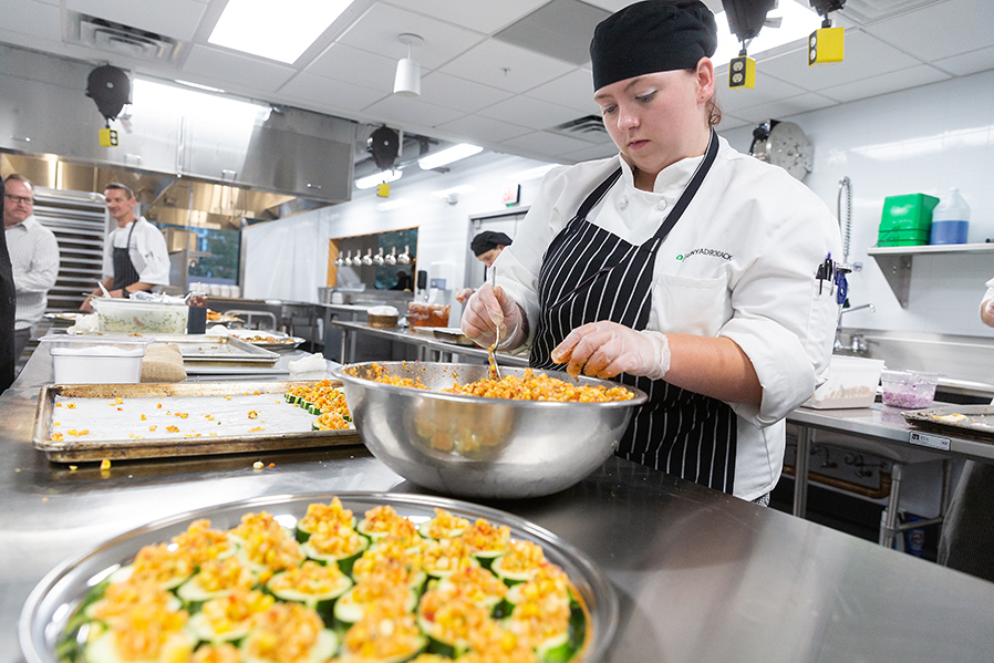 Seasoned restaurant will open for lunch and dinner service on Wednesdays and Thursdays starting Feb. 13. A culinary arts student prepares food in the kitchen from a past event.