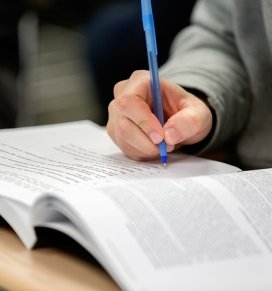 A student takes notes in a Criminal Justice class