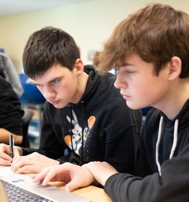 Two students work together at a computer