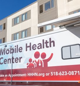 The Hudson Headwaters Health Network Mobile Health Unit is seen outside the Residence Hall