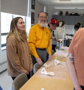 Josef Watts laughs during a discussion in a forensic anthropology course