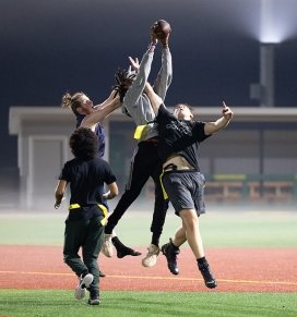 Students participate in intramural football on the college's turf field