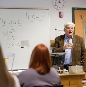 A professor teaches students in a Substance Abuse Services class