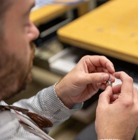 Close-up detail of hands working on computer wiring