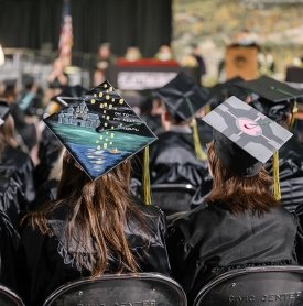 Two SUNY Adirondack graduates are seen from behind at Commencement 2024