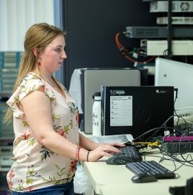 SUNY Adirondack alumna Jordan Suprenaut works at a computer terminal