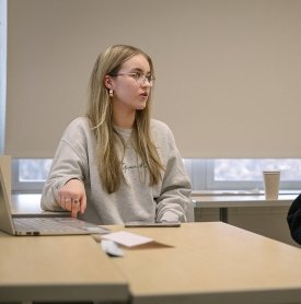 A student delivers a presentation during an English course