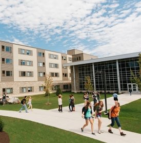 Students walk along the sidewalks surrounding SUNY Adirondack's Residence Hall