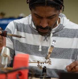 Male student working in an electrical bootcamp lab