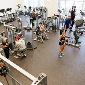 Students working out in the fitness center in the residence hall