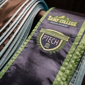 A pile of Early College Career Academy graduation sashes is seen