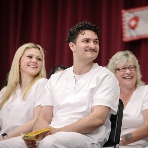 Nursing students listen attentively at their pinning ceremony