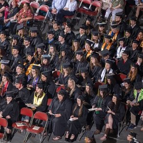 SUNY Adirondack graduates are seated in rows of chairs at commencement