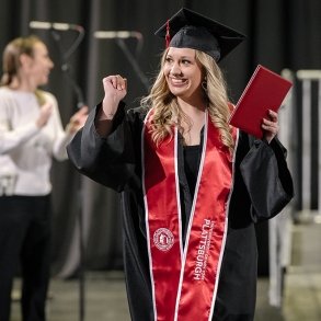 A SUNY Plattsburgh at Queensbury graduate celebrates after receiving her diploma