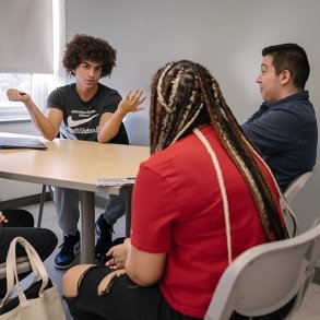 Students discuss an issue in an English class