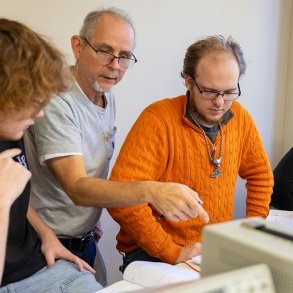 SUNY Adirondack Professor John Veitch works with two students in a Mechatronics class
