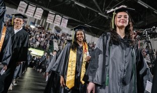 Graduates walk into commencement