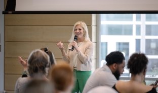 President Kristine D. Duffy, Ed.D., speaks to a group of students on campus.