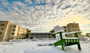 The Residence Hall is seen from the western entrance to campus on a sunny winter day