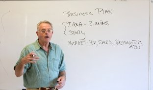 Business Professor Chandler Atkins delivers a lesson in a classroom on campus