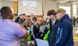 SUNY Adirondack Director of EOP Sam Johnson, left, talks to guests at SUNY Adirondack's Fall 2024 Open House event.