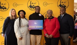 SUNY Adirondack student Xavier Baker celebrates receiving the Norman R. McConney Jr. Award for Student Excellence on March 10, with SUNY Adirondack President Anastasia L. Urtz, J.D., left, SUNY Adirondack EOP Director Sam Johnson, right, and Baker's mother and grandmother.