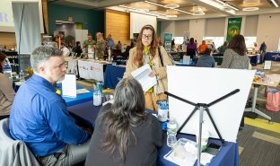 Job seekers mingle at a job fair at the college