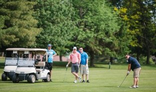A foursome golfs during the Beeman Classic Golf Tournament, a fundraiser for SUNY Adirondack Foundation