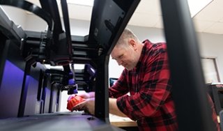 SUNY Adirondack Media Arts Professor Nick Paigo demonstrates 3D printing capabilities in the college's Media Arts Maker Space
