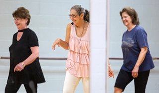 Three women dance in a Continuing Education course