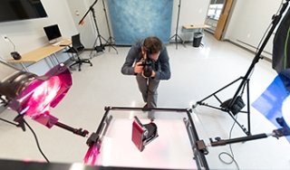 SUNY Adirondack photography instructor Brandon Segal shoots photos in the college's fully equipped studio