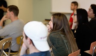 Students listen intently to a professor
