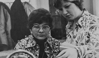 Two students work in a chemistry lab in the early days of the college