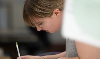 A student leans over her work