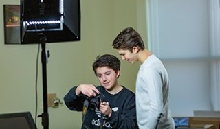 Two students work on a photography project