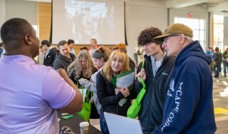 SUNY Adirondack Director of EOP Sam Johnson, left, talks to guests at SUNY Adirondack's Fall 2024 Open House event.