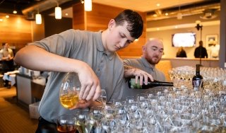 Students pour wine as part of Vintners Night at Seasoned.