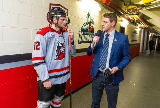 Broadcasting alumni, Brennan Down, working at the Cool Insuring Arena, interviewing a Thunder hockey player