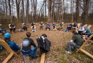 Students sitting in a circle in the outdoor classroom