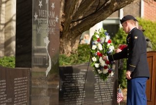 A veteran places a wreath on the on-campus Veterans Memorial during a Veterans Day ceremony