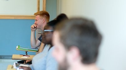 Students listen intently to a professor in class