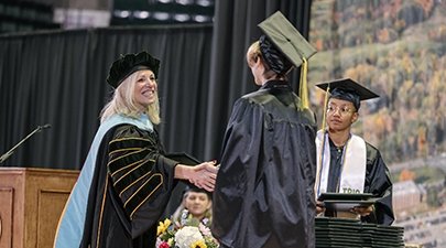 President Kristine D. Duffy congratulates a graduate