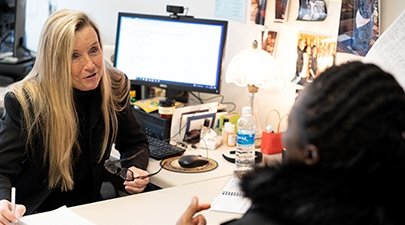 Kelli Hatin advises a student in her office